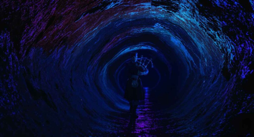 a piper in the tunnels under Edinburgh Castle | most haunted places in Europe