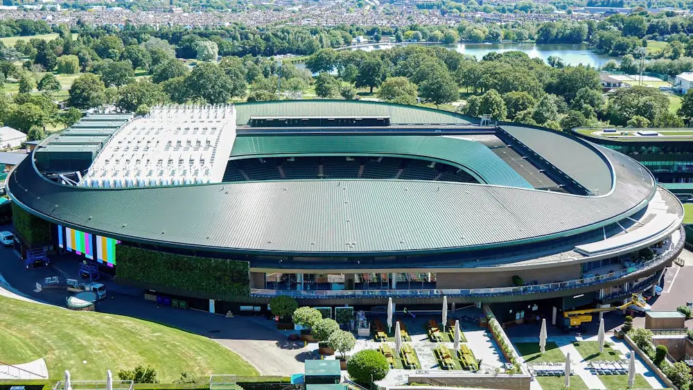 Aerial shot of the iconic Wimbledon tennis stadium in the summer.