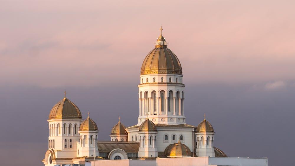 Beautiful view of an Orthodox Church in Bucharest during sunset with clear skies.