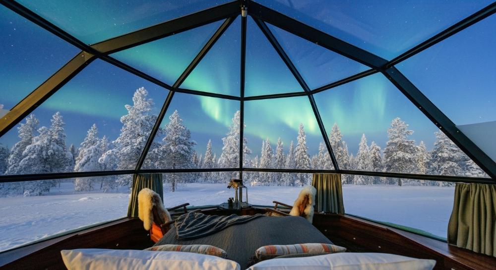Watching Northern Lights from a glass igloo