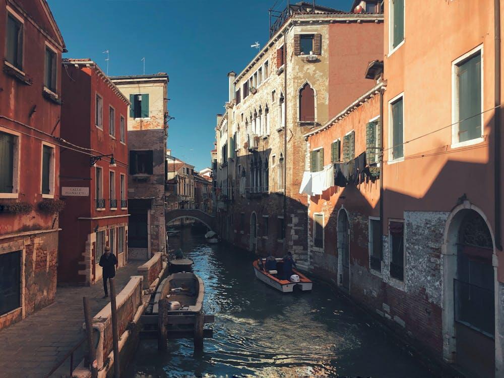 A picturesque view of a narrow canal with historical buildings in Venice, Italy in Cannaregio area.