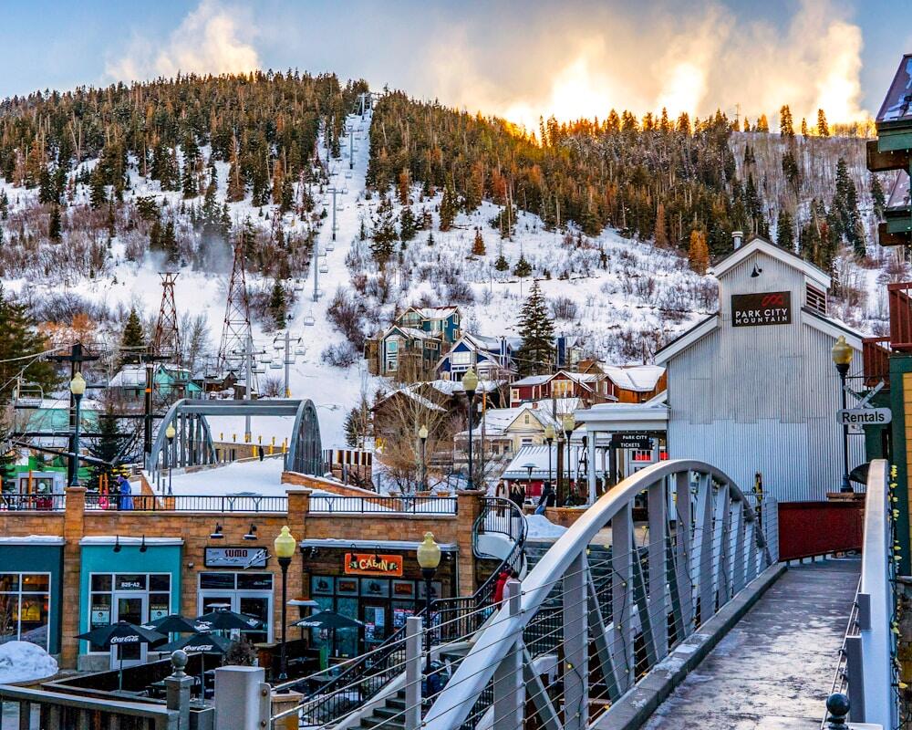 The iconic downtown Park City, Utah with the ski resort right in the backdrop and the sun reflecting through the snow being made as if it was on fire!
