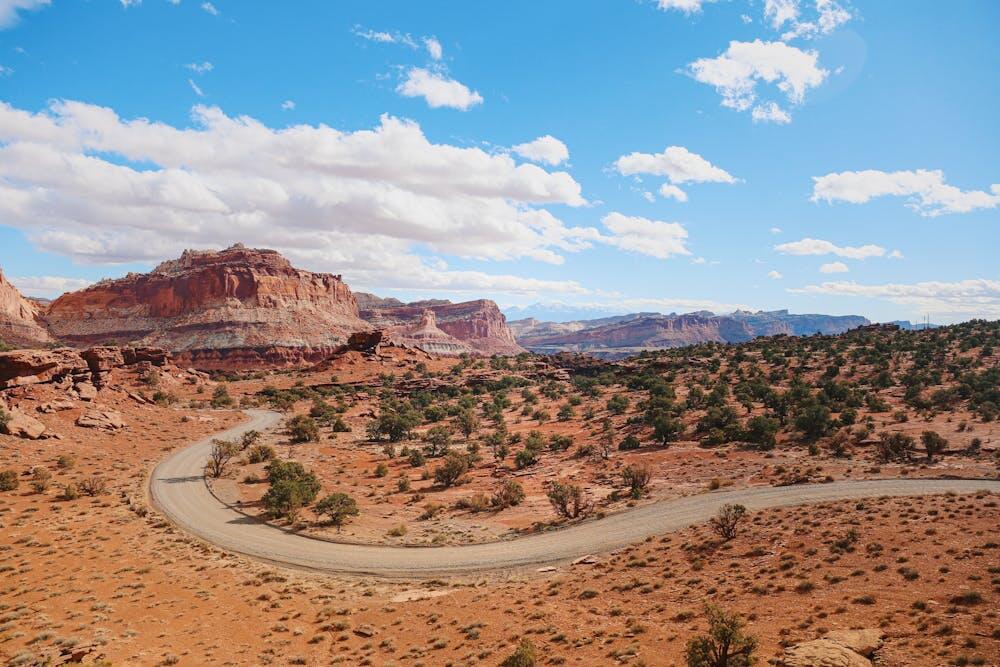 Captivating landscape of Capitol Reef National Park featuring red rock formations under a bright blue sky.