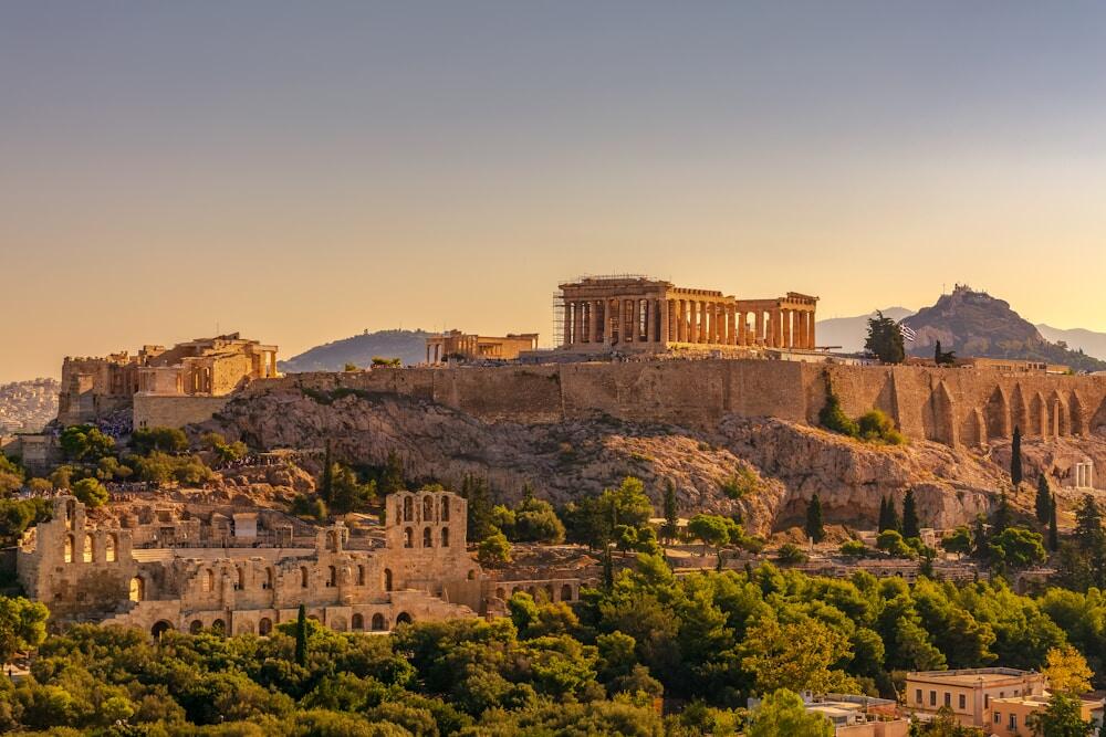 View of Acropolis of Athens with Parthenon and Erechtheion from Filopappou hill. Herodium, Lycabettus and Acropolis of Athens view from Filopappou hill a summer sunny day