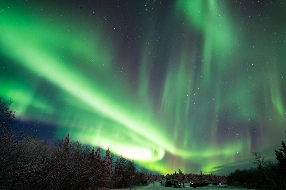 a green and purple aurora bore in the night sky of Fairbanks, Alaska