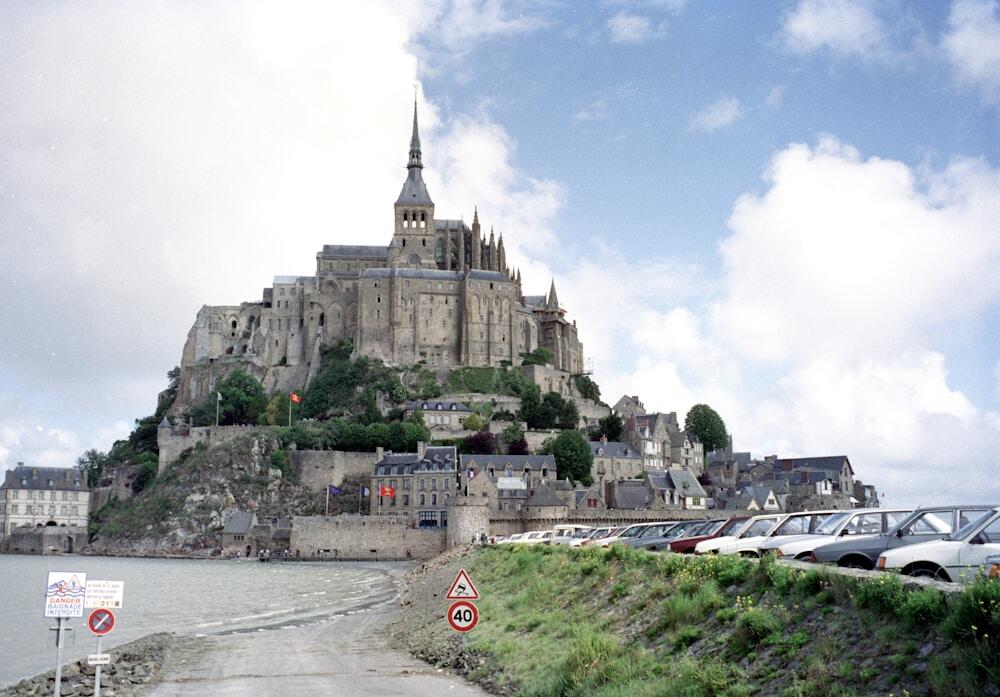 Historic Mt. Saint Michel cathedral and its surrounding village towers above the tidal bay where it is situated in Normandy