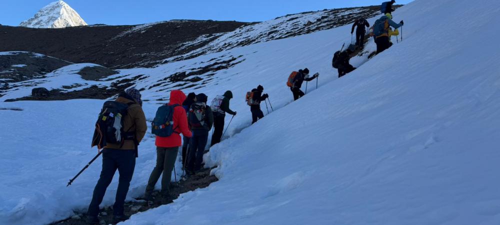 Group of hikers trekking through snow on the Everest Base Camp trail in Nepal